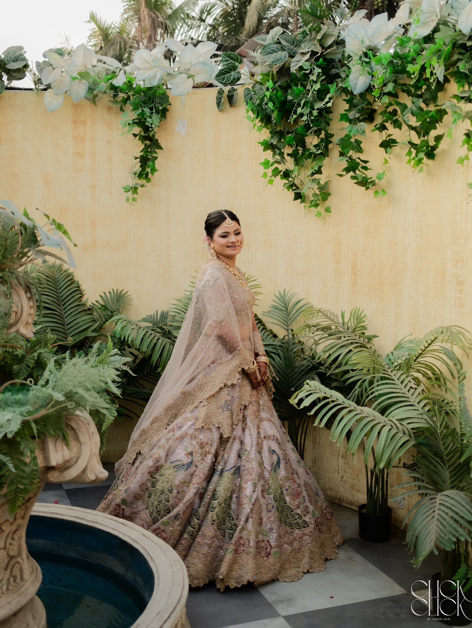 A bride walking through a lush garden setting